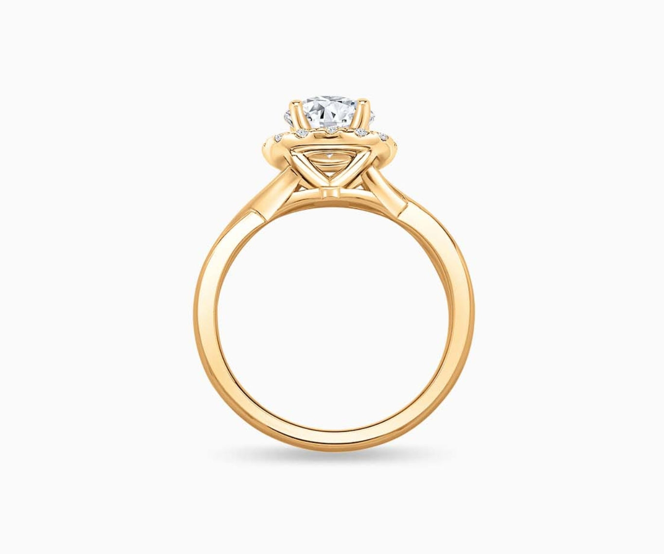 side view of Round cut diamond halo engagement ring set on yellow gold with a twisted plain band design