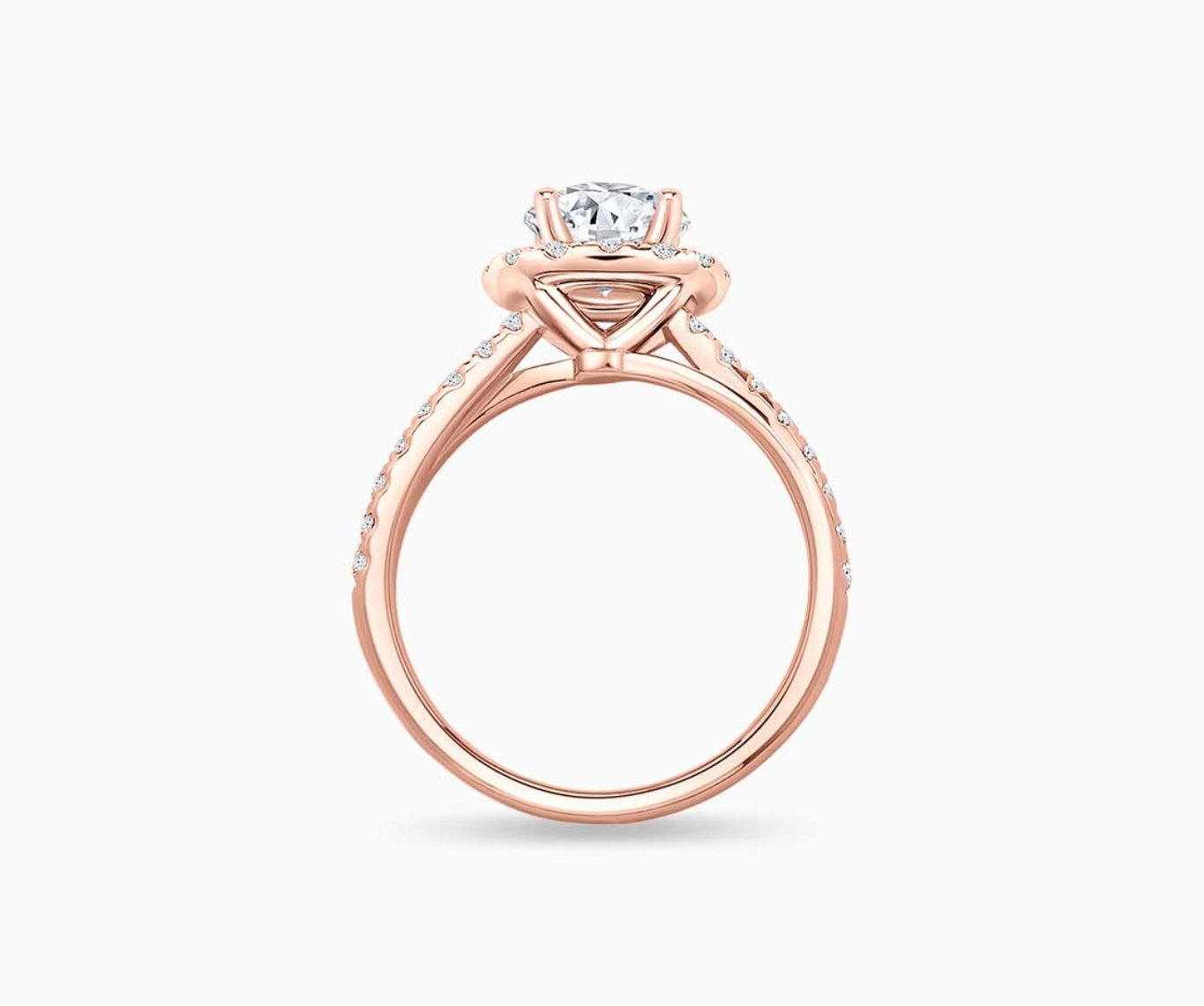 side view of round diamond halo engagement ring set in rose gold with a double pave band design