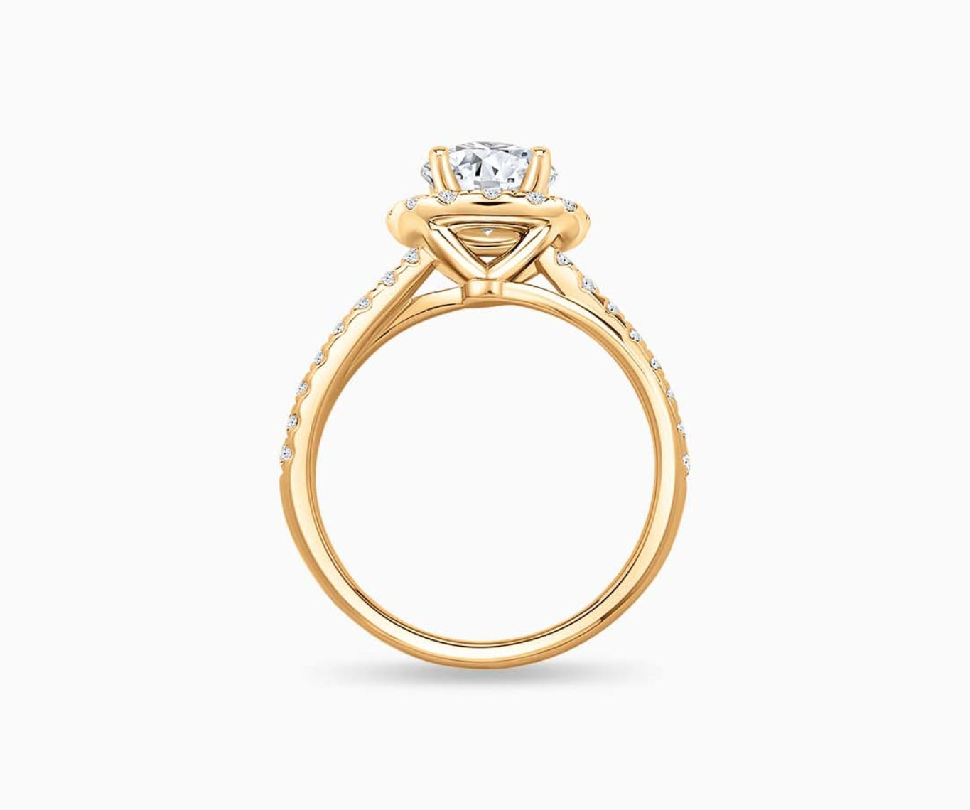side view of Round cut diamond halo engagement ring set on yellow gold with a double pave band design