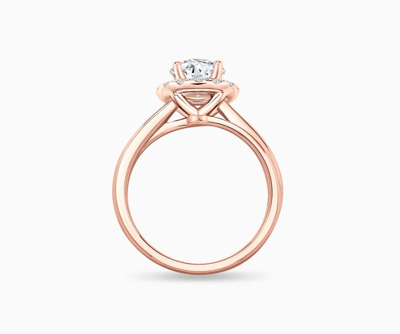 side view of round diamond halo engagement ring set in rose gold with a double plain band design