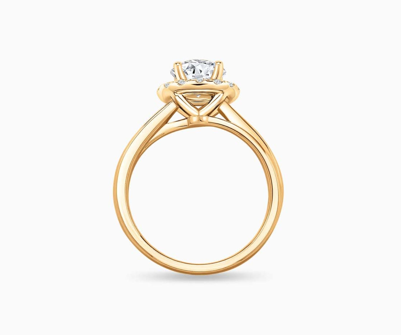 side view of Round cut diamond halo engagement ring set on yellow gold with a double plain band design