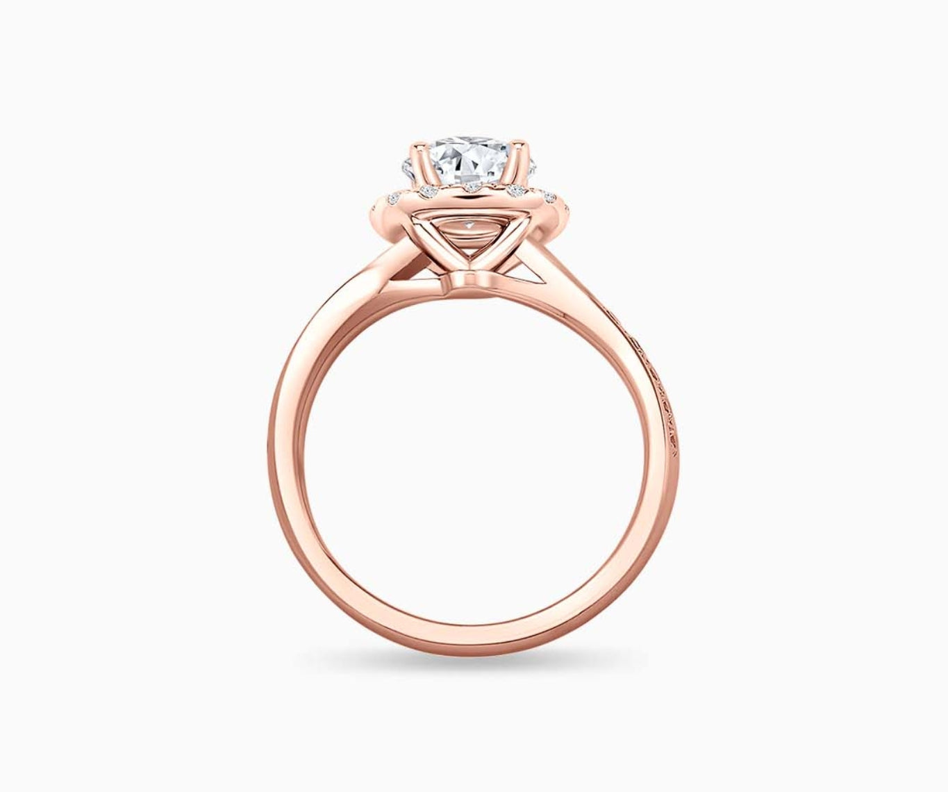 side view of round diamond halo engagement ring set in rose gold with a twirl pave band design