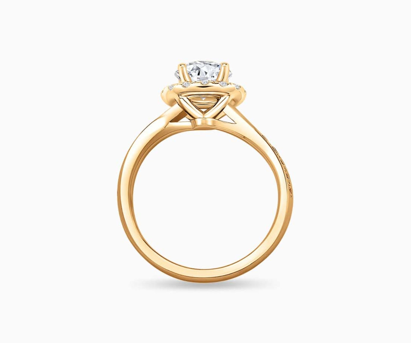 side view of Round cut diamond halo engagement ring set on yellow gold with a twirl pave band design