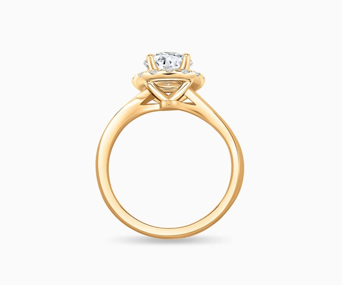 side view of Round cut diamond halo engagement ring set on yellow gold with a twirl plain band design