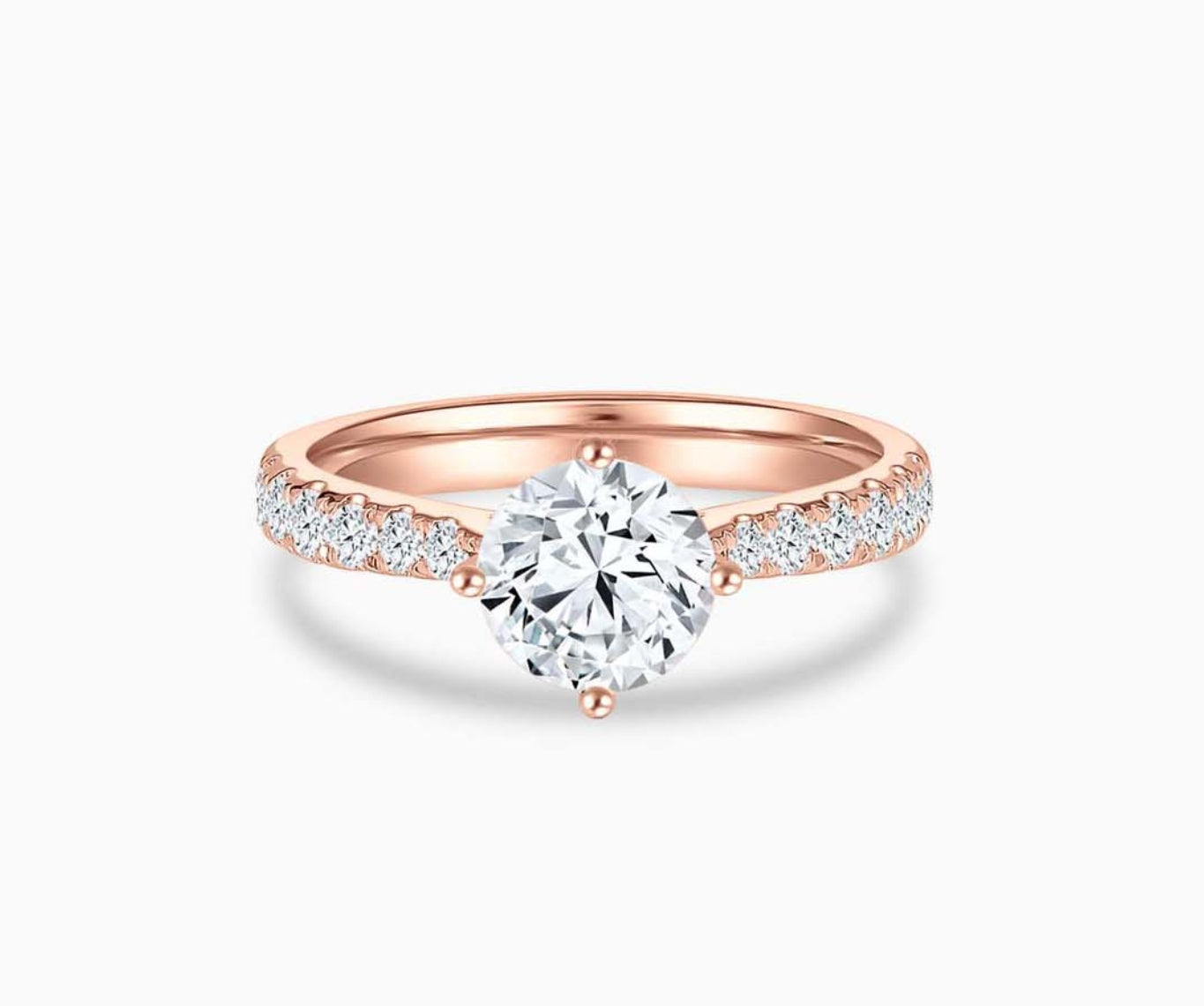 Rose gold solitaire diamond ring with a tapered band lined with side diamonds, enhancing the center stone’s brilliance and elegant appeal.