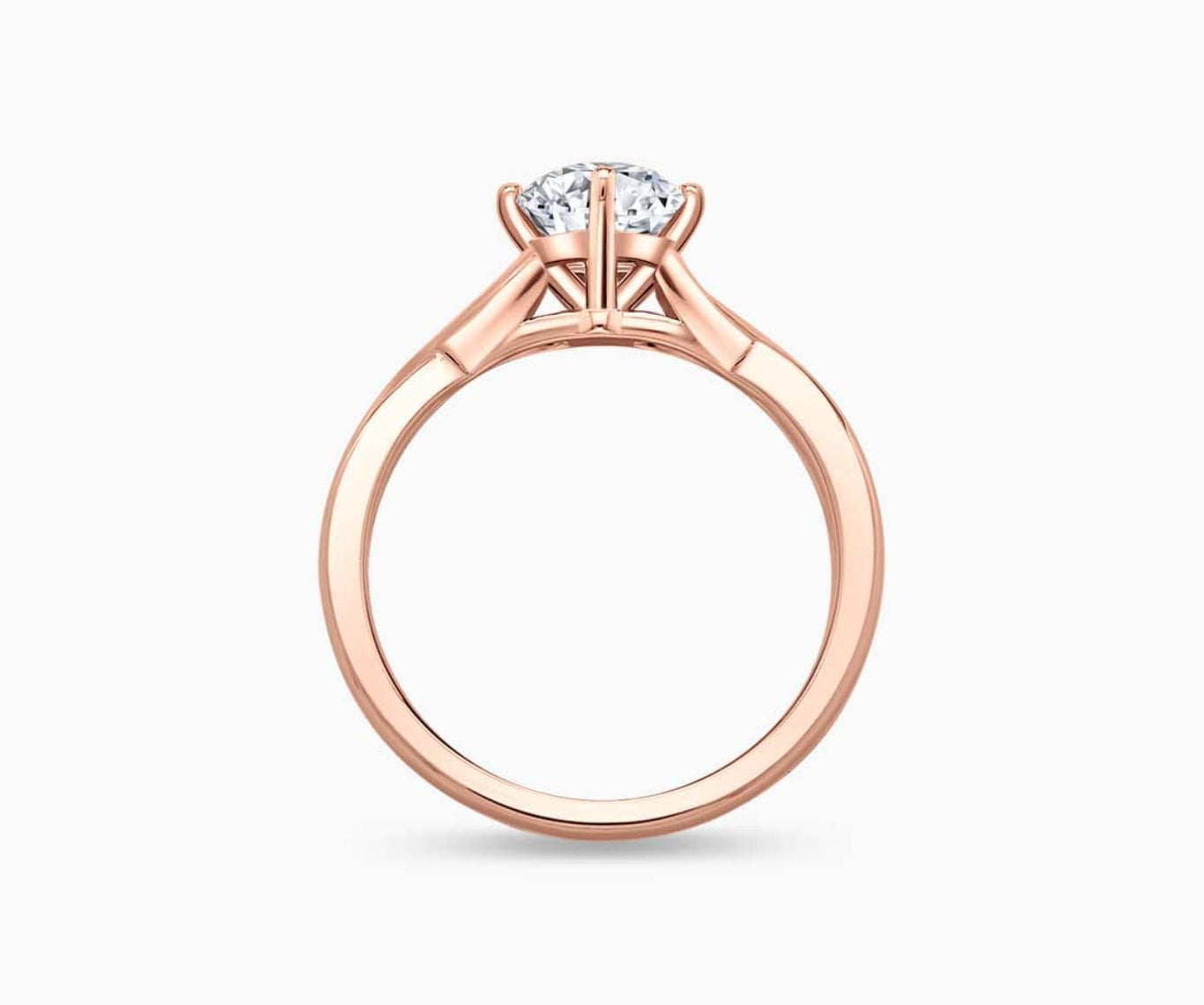 Rose gold solitaire diamond ring with a twisted infinity band, symbolizing two entwining lives in a romantic and unique design.