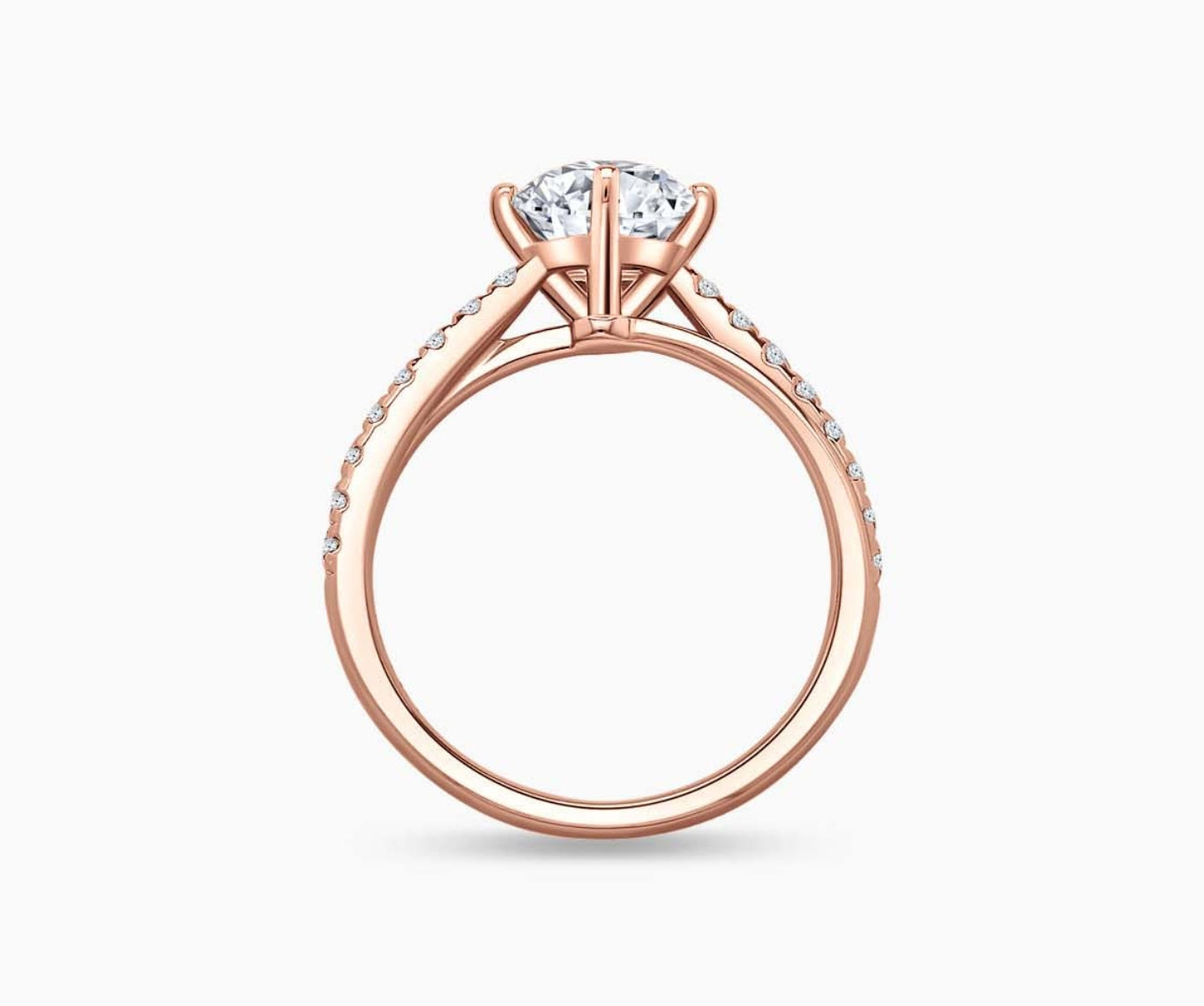 Modern rose gold solitaire diamond ring with a double pave band lined with side diamonds and a subtle center line engraving for a bold and sleek look.