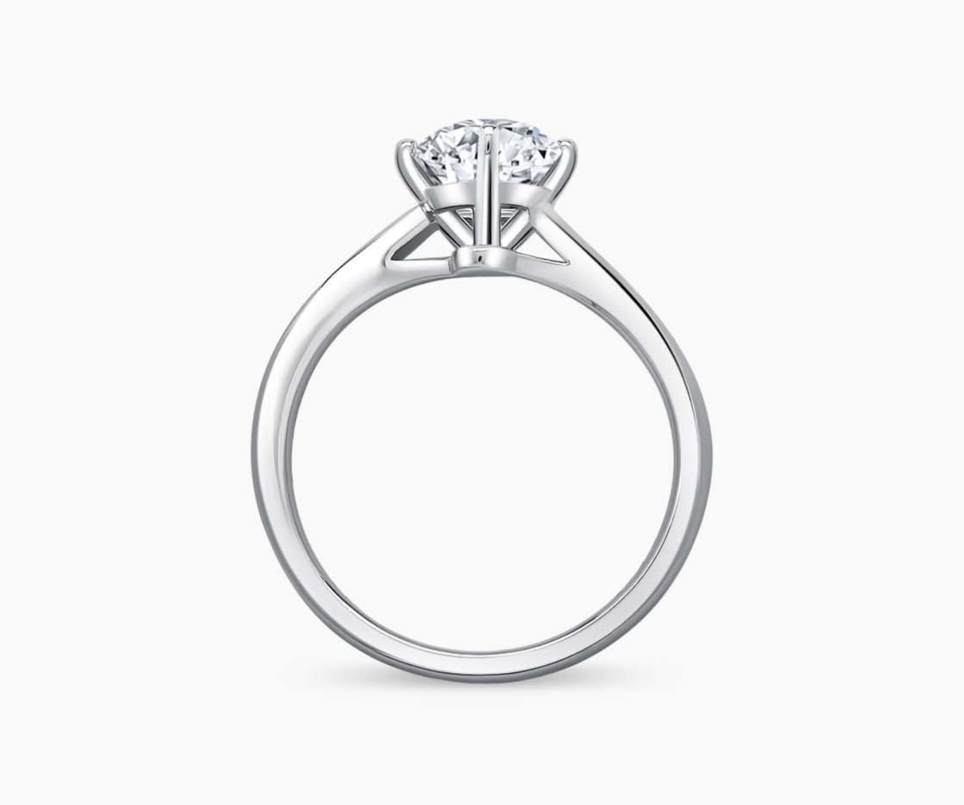 Solitaire diamond ring with a double plain twisted white gold band and a four-prong round-cut center stone