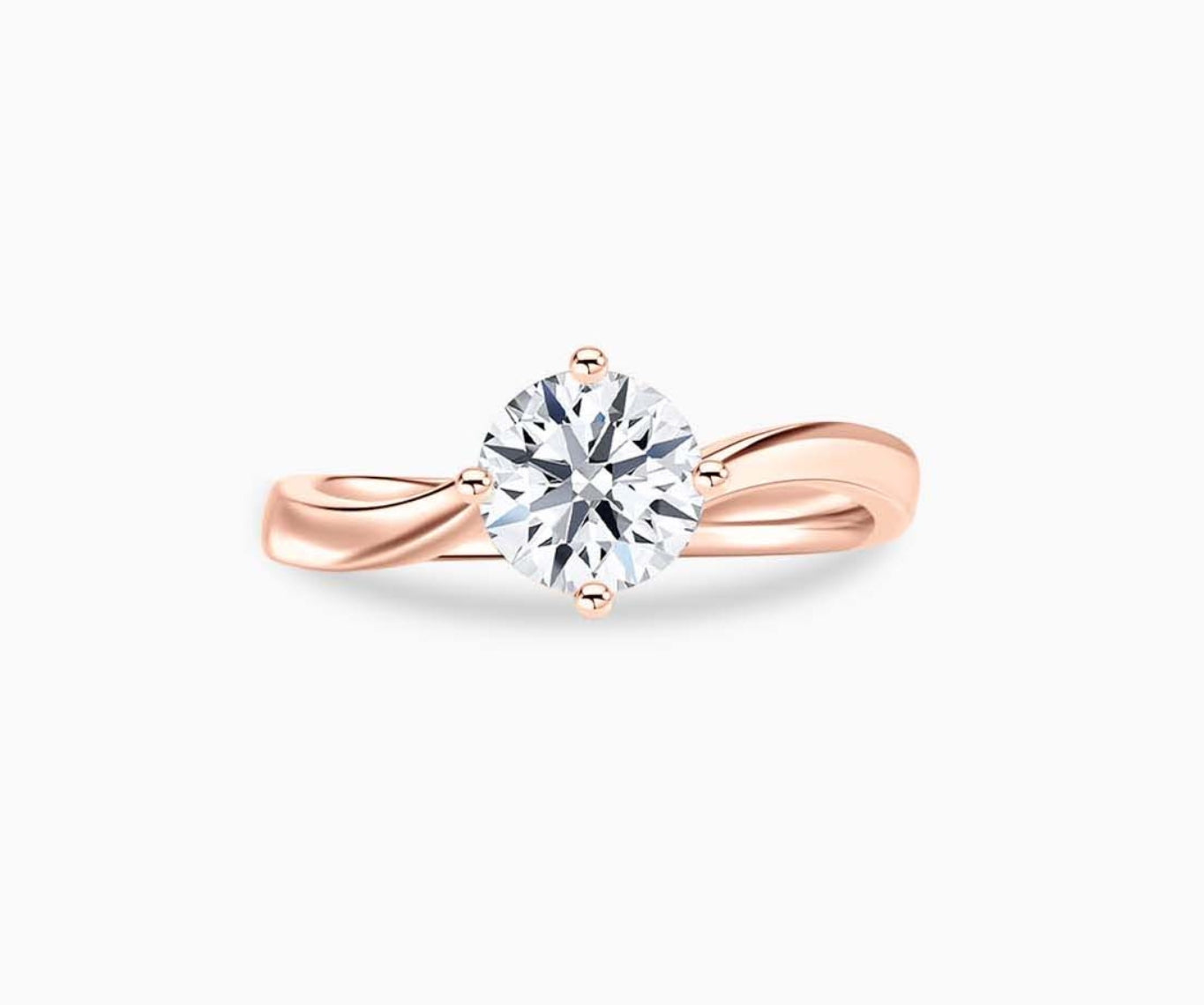 Rose gold solitaire diamond ring with a sleek twirl band, blending vintage charm with modern elegance to highlight the center stone.